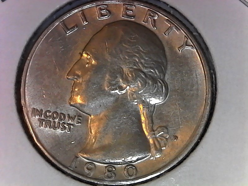 1980 Washington quarter die break cud error showing raised featureless blob at coin rim where die piece broke away